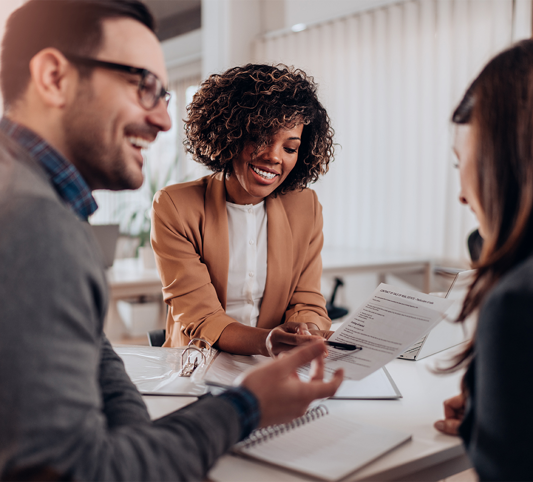 woman consulting couple across desk