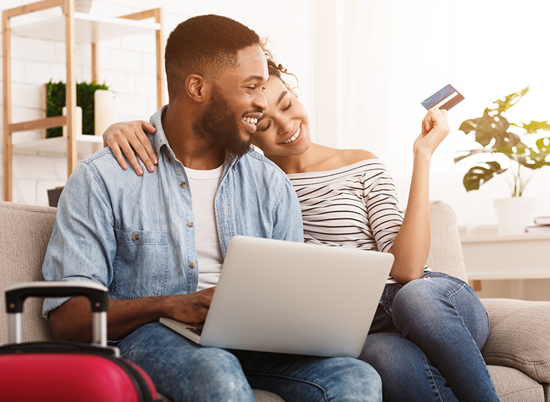 couple smiling with laptop