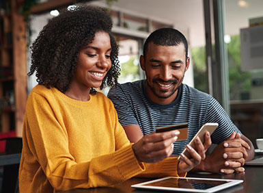 couple on tablet with credit card