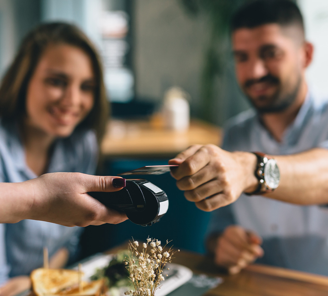 man paying for something with credit card