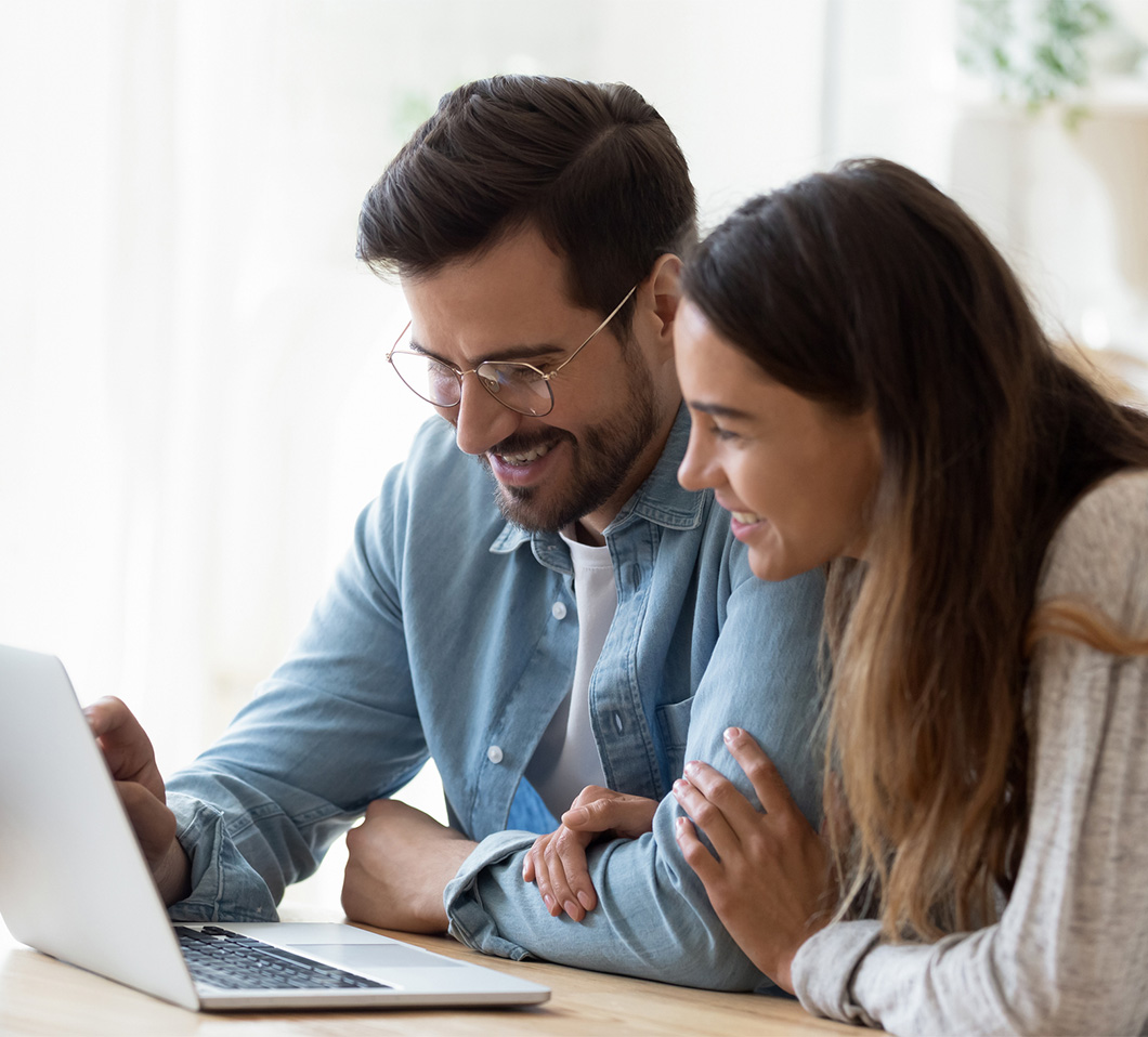 couple on laptop smiling