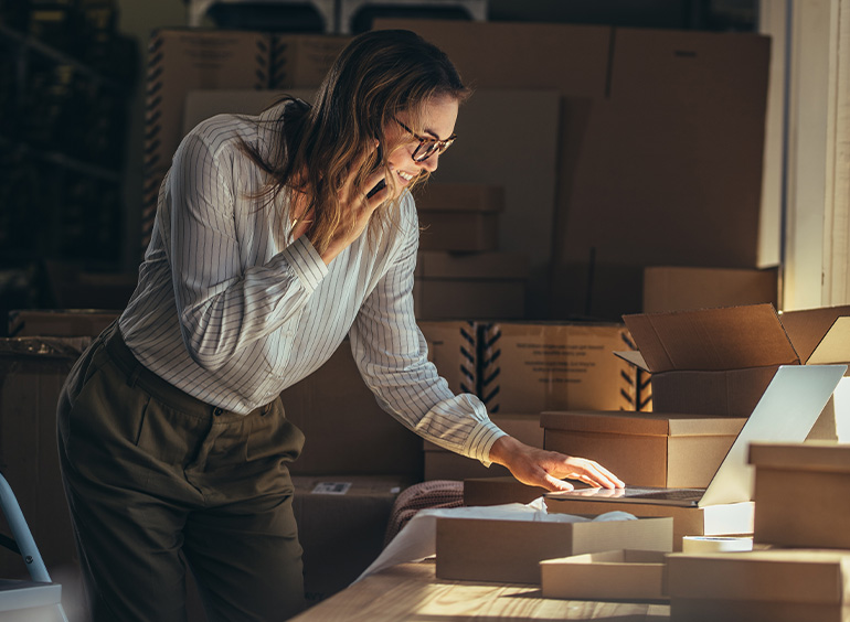 young woman processing orders for small business