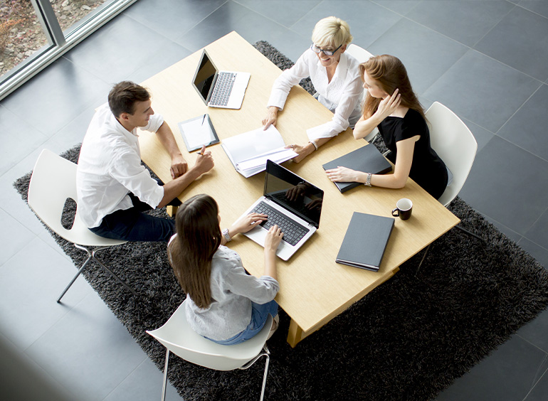 overhead view of people around conference table